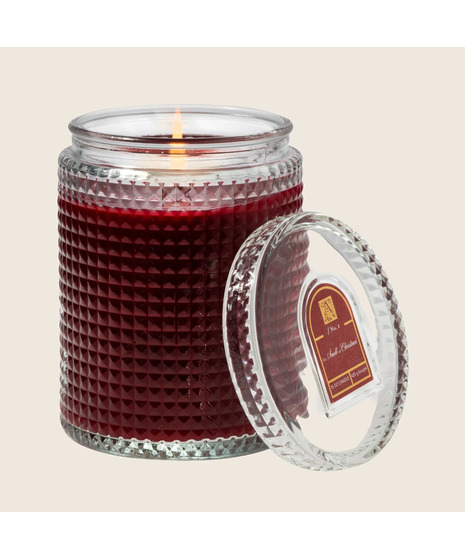 colored aromatic candle on a neutral white background