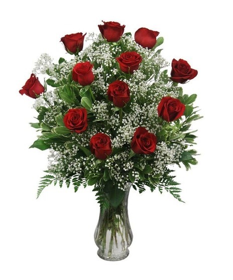 One dozen lovely long stem roses designed with greens and monte casino asters or babies breath.