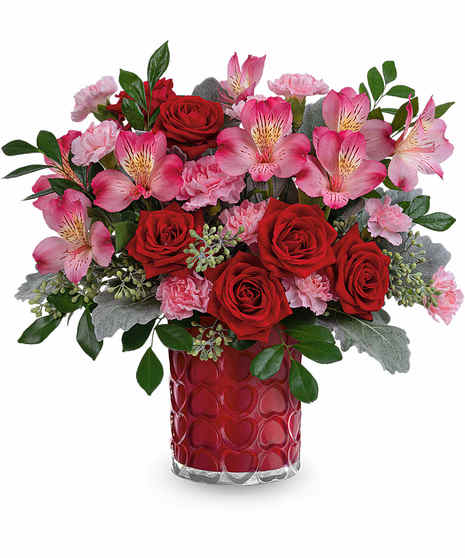 red and pink flowers in a red cylindrical container