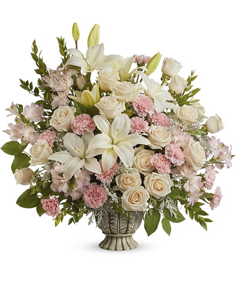 Stunning pastel roses and lilies in a calssic urn
