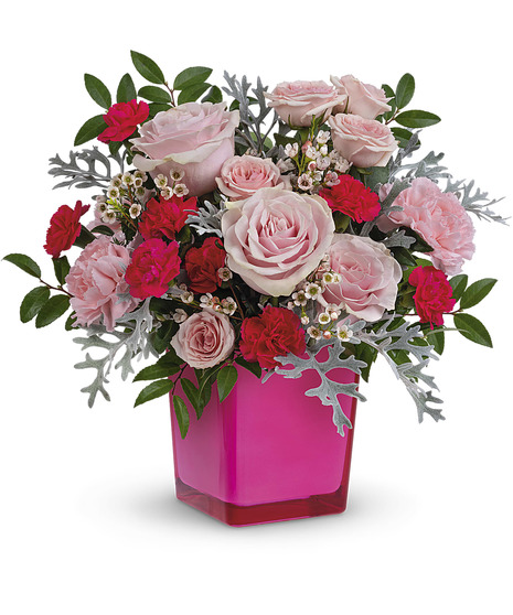 pink floral arrangement with pale roses, carnations, and more