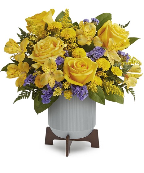 purple and yellow flowers in a modern vase